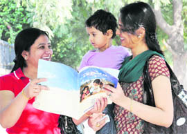 Parents go through an admission form for nursery at a school in Chandigarh on Monday.