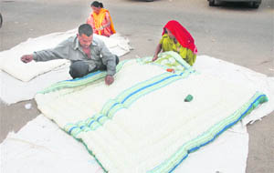 Roadside vendors prepare quilts at Sector 22 in Chandigarh on Monday.