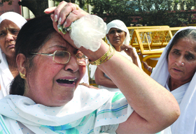 A Sikh woman breaks down during a demonstration to demand justice for the victims of the 1984 anti-Sikh riots in New Delhi on Monday. 