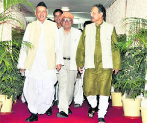 Uttarakhand Chief Minister BC Khanduri and former Chief Minister Bhagat Singh Koshiyari enter the state Assembly in Dehradun on Monday.