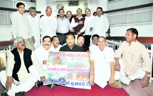 Congress legislators stage a dharna in Dehradun on Monday. 