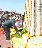 Chief Minister Prem Kumar Dhumal pays floral tributes at a memorial to former Prime Minister Indira Gandhi on her death anniversary in Shimla on Monday. 