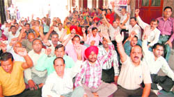 Members of the Punjab & Chandigarh College Teachers Union protest against the state government in Amritsar