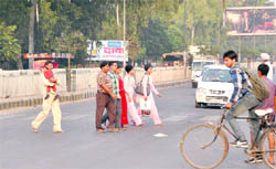 Pedestrians cross the road at Bharat Nagar Chowk in the absence of an underpass