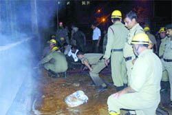 Firefighters at the basement parking of BSF office, CGO Complex, in New Delhi 