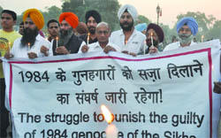 Victims of the 1984 anti-Sikh riots hold a candlelight march at India Gate, demanding punishment for the killers.