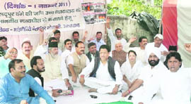 Members of the Minority Welfare Society hold a dharna near the state Assembly in Dehradun on Tuesday.