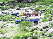 Tractor-trailers indulge in illegal mining in a river in Kangra. 