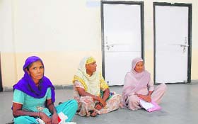 Beneficiaries of the Shagun scheme wait for cheques outside the office of the Social Welfare department in Jalandhar on Tuesday