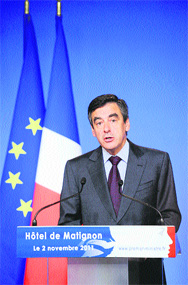 French Prime Minister Francois Fillon delivers a speech after a meeting with officials of the major French banks on Wednesday in Paris, a day after the decision of Greece's prime minister to put its EU bailout to a referendum. French stocks fell 0.22% in midmorning trading, reversing an initial rally.