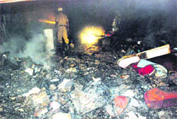 A fire official inspects a cloth shop after a fire broke out at Naya Gaon in Chandigarh