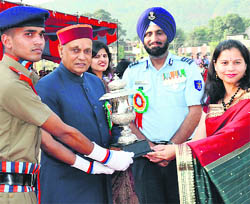 Chief Minister PK Dhumal gives away a trophy during the annual prize distribution function of Sainik School, Sujanpur, on Wednesday. 