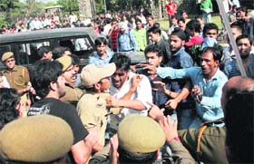 Students protesting against the new recruitment policy clash with the police outside the University of Jammu on Wednesday