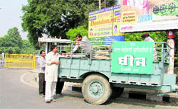 PAU employees sell seeds on a tractor-trolley at gate number 2 in Ludhiana on Wednesday