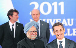 Indian Prime Minister Manmohan Singh (L) is welcomed by French President Nicolas Sarkozy as he arrives to attend the G20 summit in Cannes, France on Thursday. The leaders of the world's most powerful economies are meeting to confront a European debt crisis that threatens to plunge the global economy into renewed recession