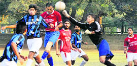 The goalie of Friends United Club tries to punch the ball away from a Khanna United Club player during a match of the 6th Harbans Lal Memorial Football Tournament at Football Stadium in Sector 17, Chandigarh, on Thursday.