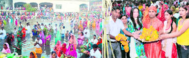 Devotees offer prayers during Chhath Puja in Gurgaon; and (right) residents perform puja rituals in Faridabad.