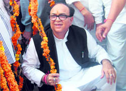 The Power, Forest and Environment Minister, Capt Ajay Singh Yadav, is weighed against coins in Rewari.