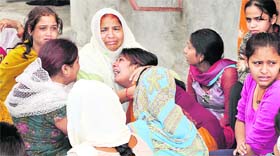 Relatives of the victims who died in a road mishap grieving at Abadpura in Jalandhar on Thursday