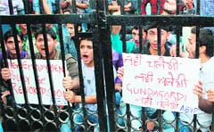Students hold a protest against the new recruitment policy of the state government at the University of Jammu 