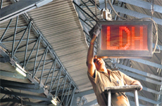 A railway employee cleans an electronic display board on the platform ahead of the Railway Ministers visit. 