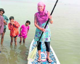 Michele paddleboards across the Ganges