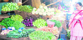 With prices touching sky high, a woman at an Amritsar market finds it difficult to buy vegetables.