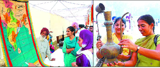 Karnail Singh of Bishnandi village (left) shows a hand woven carpet that he had made in 1971, to the visitors at Prof Mohan Singh Mela being held at Thermal Sports Stadium in Bathinda on Friday; visitors marvel at an antique.