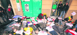 Anti G20 demonstrators lie in front of a bank as they take part in a protest against globalisation on the second day of the G20 summit in Cannes, France on Friday.