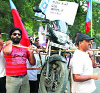 AISF activists protest against the hike in petrol price in New Delhi on Friday.