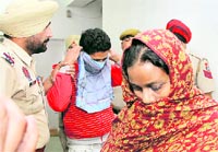 Sunita Devi (extreme right) along with her paramour, Gurjit Singh (centre), in the police custoday in Jalandhar on Friday