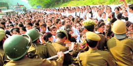 Girl students are held back by the police during a protest against the state governments new recruitment policy in Jammu on Friday.