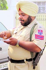 An overweight police personnel savours snacks in Jalandhar on Friday
