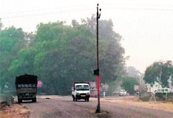 An electricity pole erected in the middle of a road along the Sirhind Canal near Mandi Ahmedgarh. 