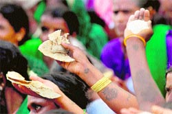 Members of Stree Shakti Sene show rice and chapatis during a rally against corruption in Bangalore on Friday