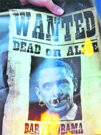 A protester burns a photo of US President Barack Obama during an anti-US gathering in front of the former US embassy in Tehran on Friday