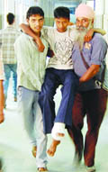 Attendants carry a patient on their shoulders in the absence of a wheelchair at Guru Nanak Dev Hospital in Amritsar
