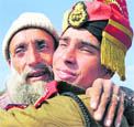A new recruit hugged by his father after the parade.