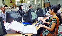 Computer operators digitise land records in the tehsil complex in Jalandhar