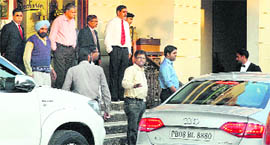 Officials of Directorate of Revenue Intelligence take away cars belonging to Gautam Kapoor in Jalandhar on Saturday.