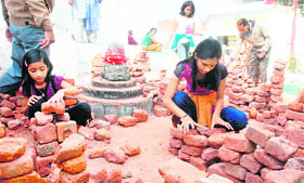 Children assemble bricks to wish for a house at the temple complex in Amritsar.