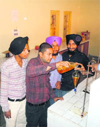 Students of KC College of Engineering and Information Technology demonstrate preparation of bio-diesel from linseed oil in Nawanshahr on Sunday. 