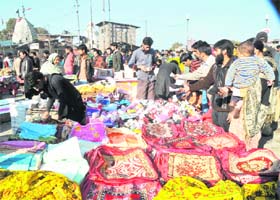 Shoppers throng a market in Srinagar on Sunday