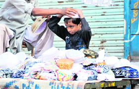 A child tries a cap before buying it