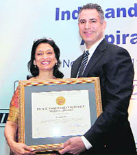 Under Secretary for International Trade, US Department of Commerce, Francisco Sanchez presents 'Peace through Commerce Medal Award' to Dy Director-General, CII, Kiran Pasricha (L) during a CII session on "India and the USA in the 21st Century: Aspirations and Collaborations" in New Delhi on Monday.