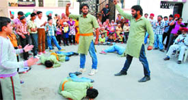 The arists of the Natya Manch from Jaito in Faridkot performing a steet play as part of the ongoing 12-day drama fest being held in the memory of Bhai Gursharan Singh at Hazurkapura locality in Bathinda on Monday.