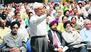 An elderly person asks a question from police officials during interaction.
