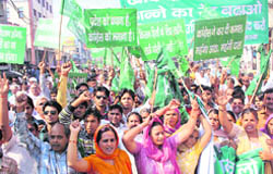 INLD workers take out a protest march against price rise in Rohtak 