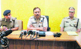 AK Dhull (centre), Police Commissioner, Ambala, addresses mediapersons at Ambala Cantt.