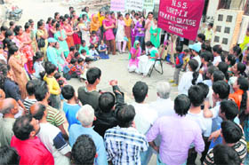 NSS volunteers of KVA DAV College for Women perform a nukkad natak on women education at Ambedkar Basti in Karnal. 